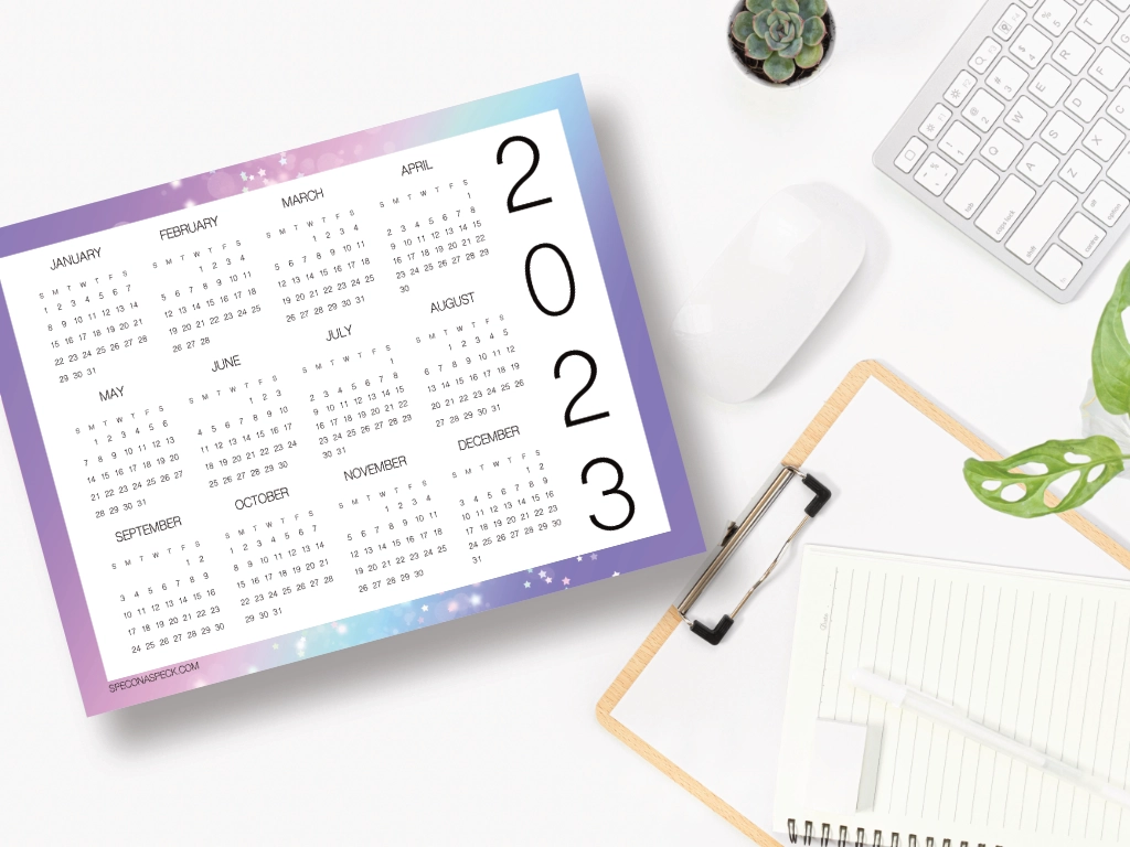 2023 year at a glance with the years dates on a desk with clipboard mouse and keyboard
