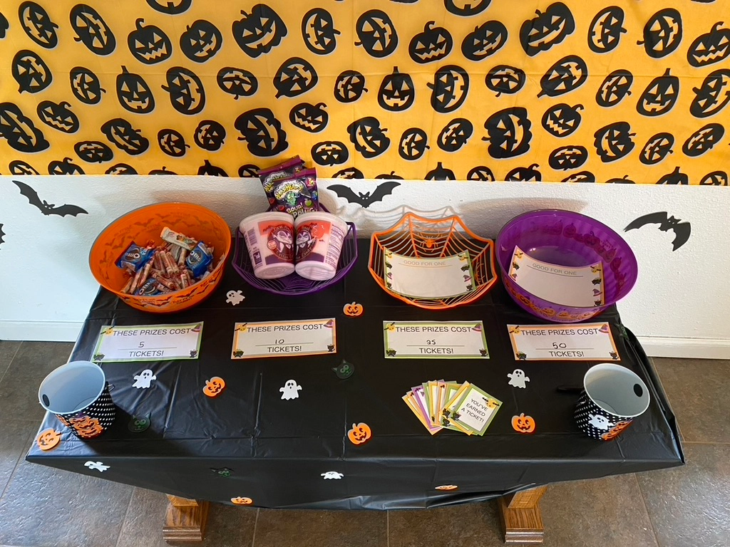 halloween bowls on a table with the reward tickets printed and cut out