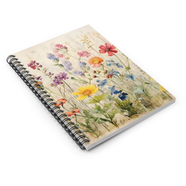 a table top view of a spiral notebook with wildflowers on the cover