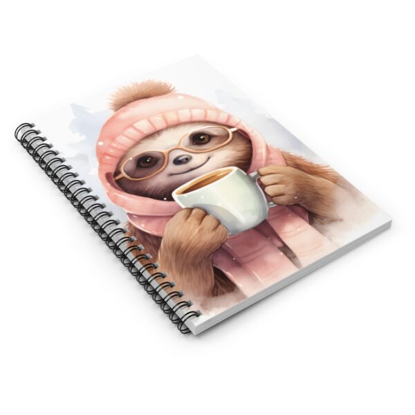 sloth notebook with spiral binding on a a flat surface with a sloth drinking coffee
